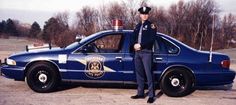 a police officer standing next to his patrol car