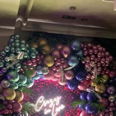 a christmas wreath made out of balloons and ornaments