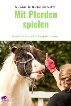 a woman petting a small pony with the words mitt pferden spieln on it