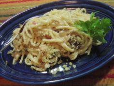 a blue plate topped with pasta and meat