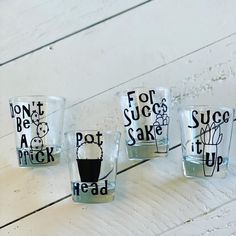 four shot glasses with different designs on them