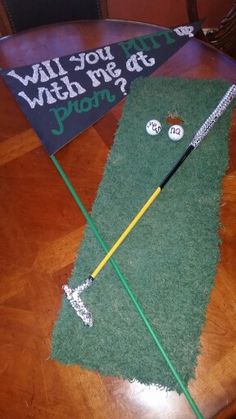 Super cute Promposal for a girl who's into golf. #promposals #promposalideas Green is an old piece of carpet spray painted. Putter is an inexpensive putter from an old kid's set blinged out with crystals from the craft store. Sign is painted letters with silver glitter added to the white lettering. Note that the painted letters have a higher impact than on than white poster board. Prom Posals Ideas Golf, Golf Promposal Ideas, Promposal Ideas Golf, Homecoming Proposal Ideas Golf, Hoco Proposals Ideas Golf, Golf Sadies Proposal, Golf Promposal For Him, Hoco Response Ideas, Dance Responses