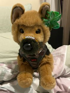 a stuffed animal is sitting on a bed