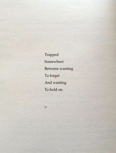 an open book with the words trapped somewhere between wanting to forget and wanting to hold on