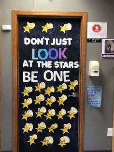 a door decorated with stars and the words don't just look at the stars be one