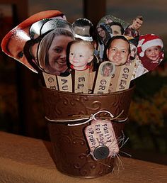 a cup filled with lots of different pictures on top of a table