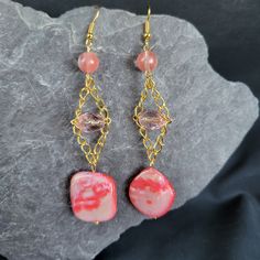 Add a playful pop of color to your accessory collection with our Pink Shell Trapeze Earrings! Made with a pink shell bead on a trapeze chain, these earrings also feature clear pink and round pink beads for a fun and unique look. Perfect for any occasion! Pink Beads, Shell Beads, Style Earrings, Gemstone Earrings, Jewelry Earrings Dangle, Etsy Earrings, Color Pop, Dangle Drop Earrings, Dangle Earrings