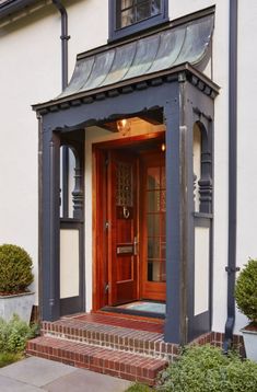 an entrance to a house with steps leading up to it