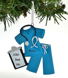 an ornament shaped like a doctor's coat and stethoscope hanging from a christmas tree