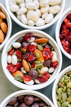 several bowls filled with nuts and seeds on top of a table next to text that reads festive trail mix