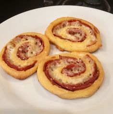 three small pastries on a white plate