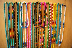 a bunch of bracelets that are hanging on a wall