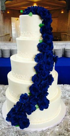 a wedding cake with blue flowers on it