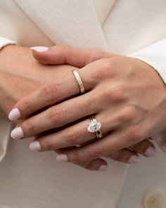 a woman's hand with two rings on it