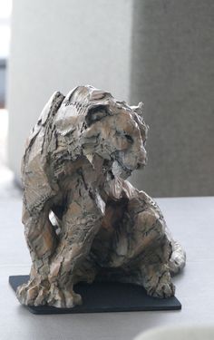 a sculpture of a bear sitting on top of a table