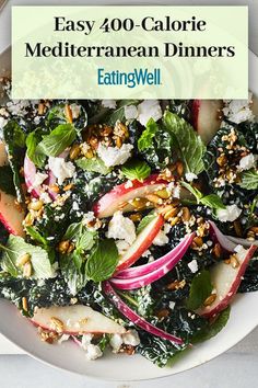 a white plate topped with salad covered in spinach