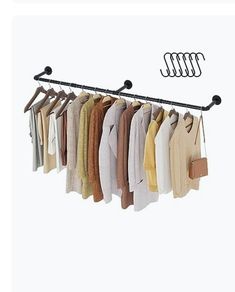 there is a rack with clothes hanging on it and the hangers are holding sweaters