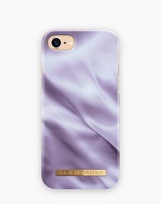 an iphone case with purple silk on the back and gold lettering that says ideal sweden