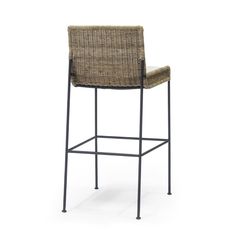 an upholstered bar stool with a black frame and wicker seat, against a white background