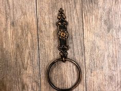 an old fashioned metal ring on a wooden surface with wood grained boards in the background