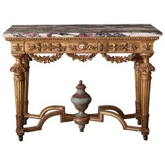 an ornately decorated console table with marble top