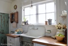 a kitchen with an old fashioned sink and wooden counter tops