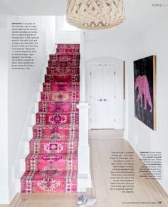 a pink rug is on the floor next to stairs