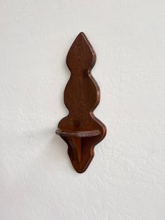 a wooden shelf mounted to the side of a wall