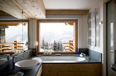 a bath room with a large tub and a window