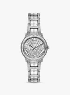 As a opulent accent to everyday looks or a precious gift to a loved one, the limited-edition Sage watch delivers a maximum dose of sparkle in a chic, minimalist package. Crafted from stainless steel, this silver-tone timepiece features a glittering pavé-encrusted bracelet strap and dial for statement-making appeal. A three-hand quartz movement and Roman numeral time stops add a classic finish. Its slender casebody reverses to reveal Michael’s signature and a unique identification number, while t Luxury Stainless Steel Diamond Watch With Metal Dial, Luxury Stainless Steel Diamond Watch For Anniversary, Luxury White Gold Diamond Watch, Luxury Stainless Steel Diamond Watch, Luxury White Gold Stainless Steel Watch, Modern Silver Diamond Watch With Diamond Accents, Luxury Silver Diamond Watch In Stainless Steel, Luxury Stainless Steel Watches With Diamond Accents, Luxury Silver Stainless Steel Diamond Watch