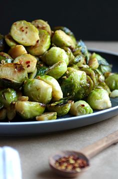 brussel sprouts on a plate with wooden spoon