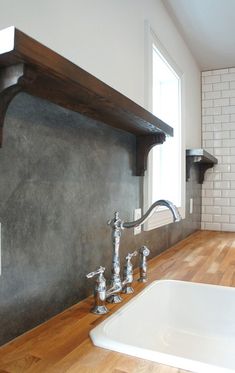 a kitchen with a sink, stove and wooden counter top in it's center