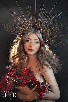 a woman with flowers in her hands and a crown on her head is holding a bouquet