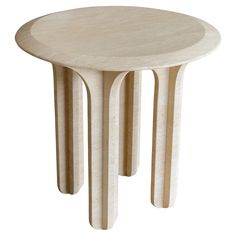 a white table with three wooden legs and a circular design on the top, against a white background