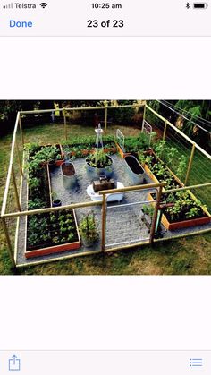 a garden with lots of plants in the middle of it and an open area for seating