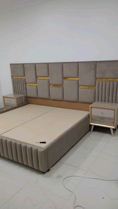 a bed that is in the middle of some kind of room with no sheets on it