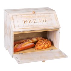 an open bread box with fresh baked goods in the front and side, on a white background