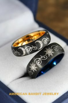 two wedding rings sitting on top of each other