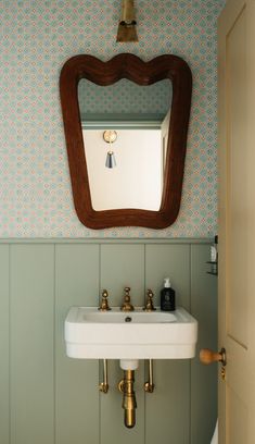 a sink and mirror in a small room