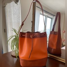 Beautiful Bag In Great Condition. Exterior Has A Minor Pen Mark. Interior In Good Condition - Some Pen Markings And Scuffs. Orange Bucket Bag For Travel, Orange Bucket Bag With Removable Pouch For Shopping, Orange Satchel Bucket Bag For Daily Use, Orange Rectangular Bucket Bag For Shopping, Luxury Orange Bucket Bag, Orange Bucket Bag With Removable Pouch, Vintage Orange Bag For Everyday Use, Orange Leather Bucket Bag For Travel, Orange Bucket Bag For Daily Use