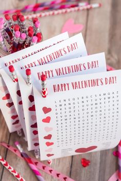 valentine's day printables are displayed in front of candy sticks