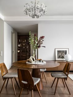 a dining room table with four chairs around it