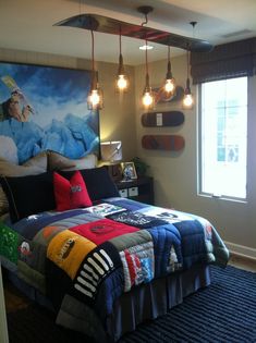 a bed room with a neatly made bed and two lamps hanging from the headboard