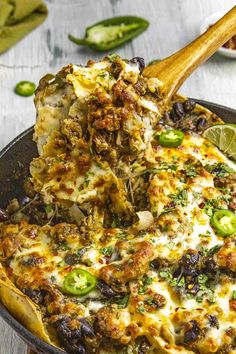 a skillet filled with mexican food and garnished with jalapenos