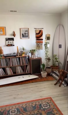 a living room filled with furniture and a surfboard