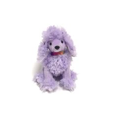 a purple stuffed dog sitting up against a white background