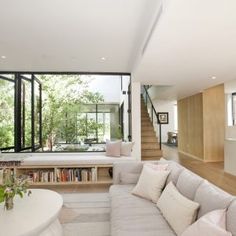 a living room filled with furniture and windows