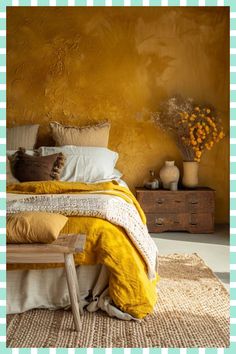 a bed with yellow sheets and pillows in a room that has gingham checkered walls