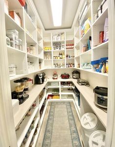 an organized pantry with white shelving and lots of food