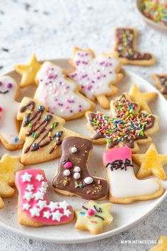 a white plate topped with lots of decorated cookies